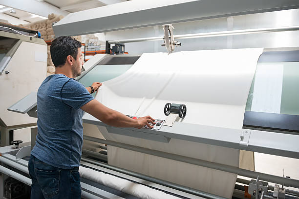 textile quality controller checking fabrics in the textile mill