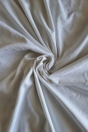 High-quality image of white cotton fabric with a swirling pattern. Ideal for textile and interior design concepts.